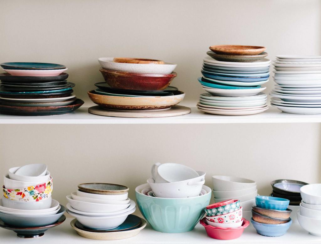 Image plates and bowls on shelves - by Brooke Lark https://unsplash.com/@brookelark